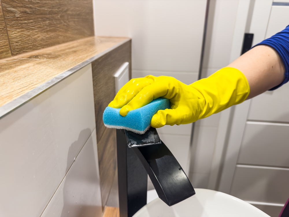 What is the best way to clean around faucet bases?